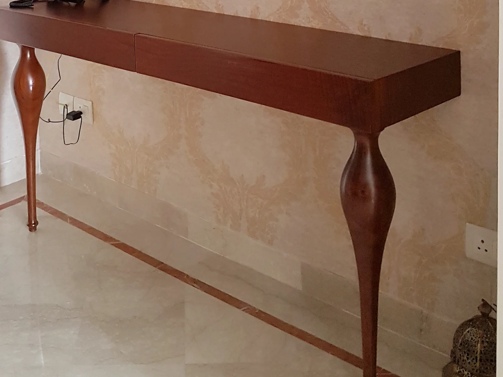 Sculptural curved-leg wood console.