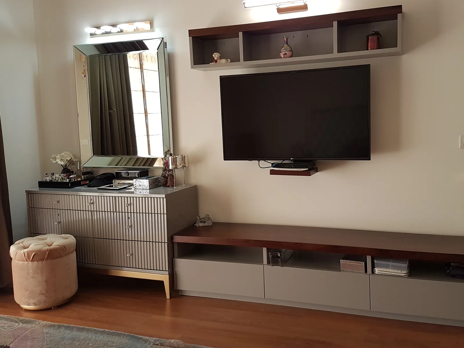 Wall-mounted floating media unit with a fluted fascia design.