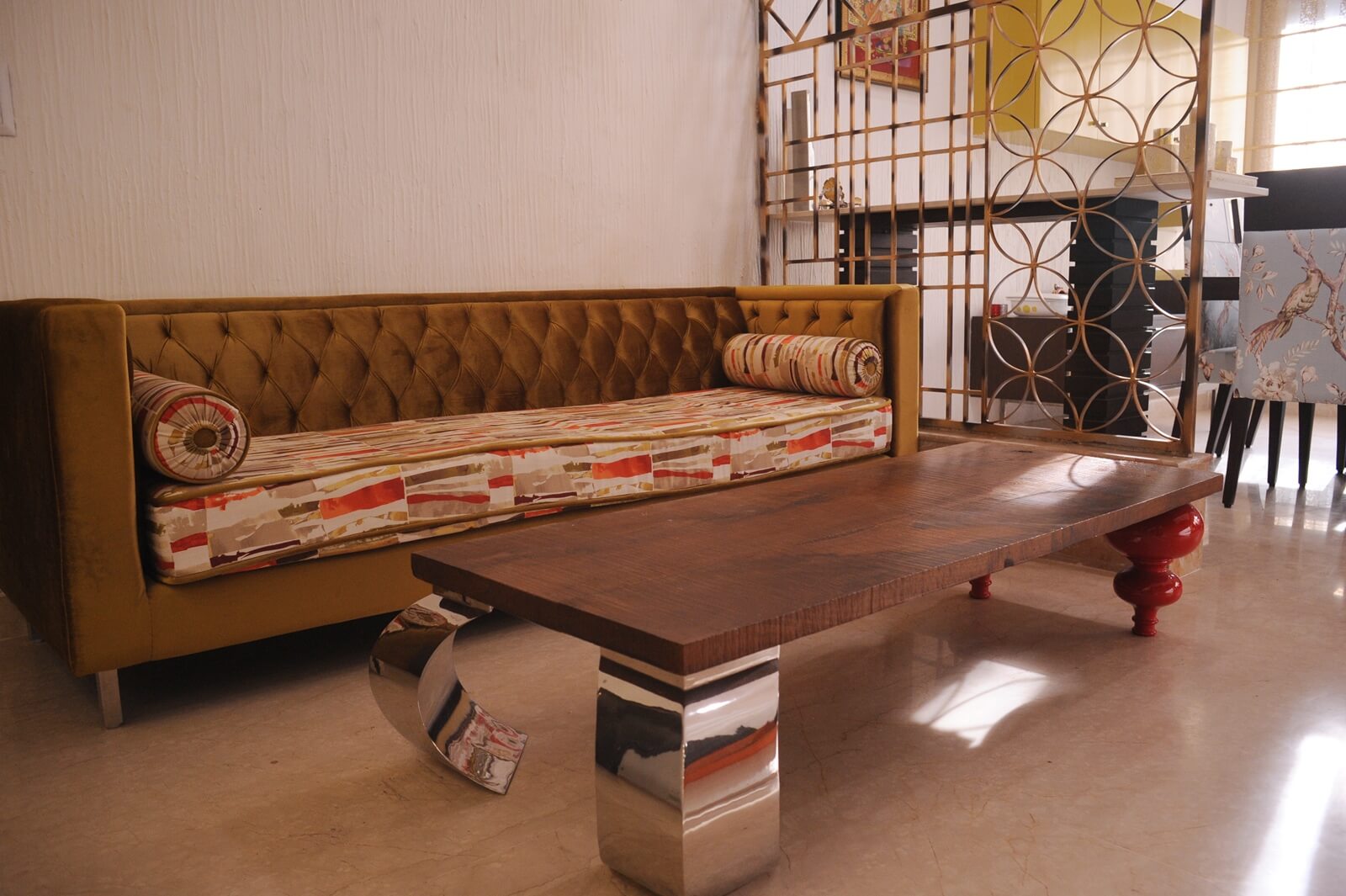 Mustard tufted sofa with steel accent table