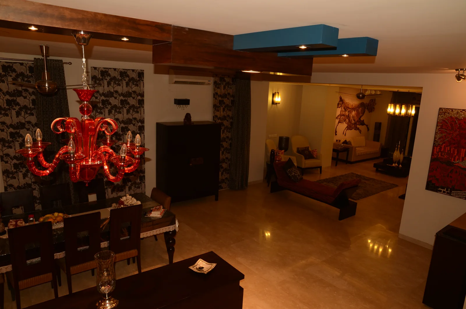 Custom wood beam ceiling and red chandelier at Palm Springs Villa, Gurgaon by SpaceTalk Designs
