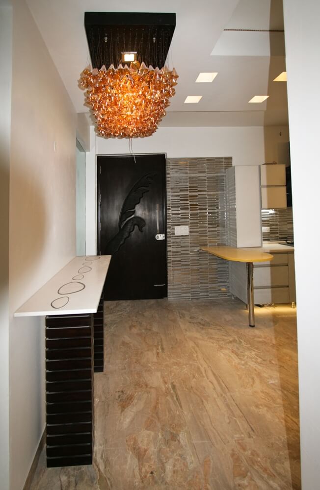 Open kitchen and entrance console by SpaceTalk Designs, Gurgaon