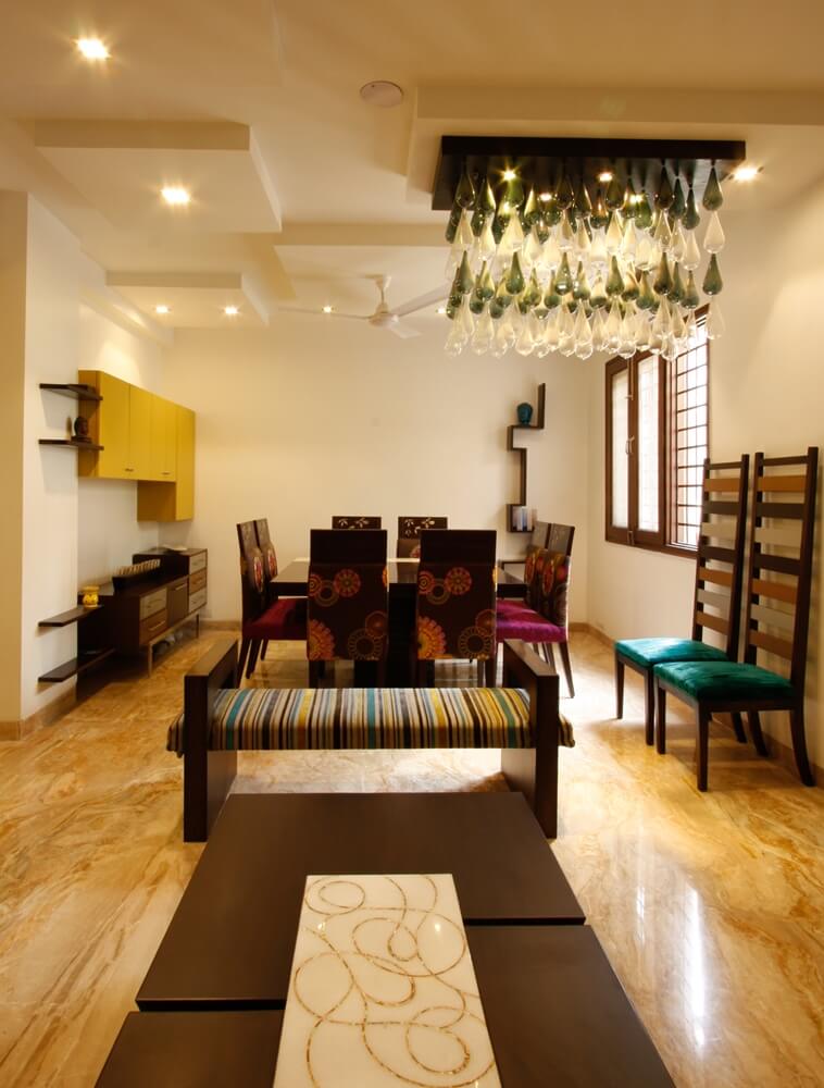 Living room with custom chandelier and furniture by SpaceTalk Designs, Gurgaon