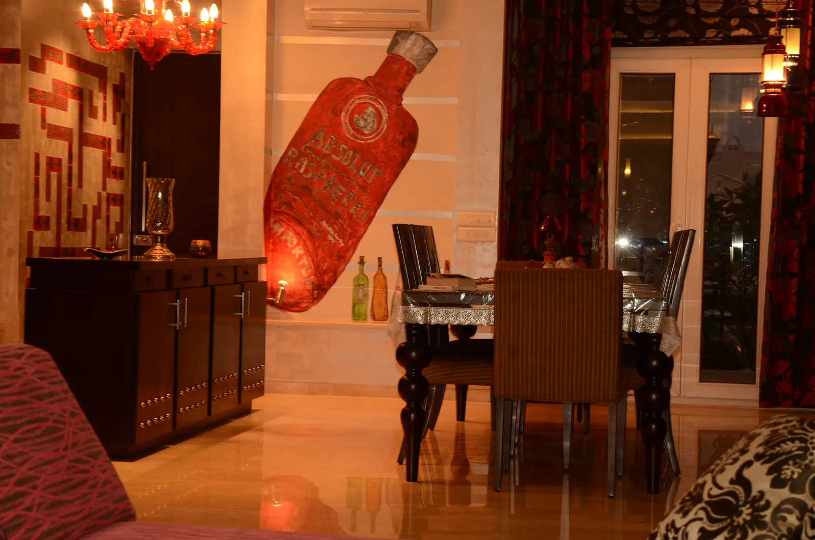 Custom dining and entertainment area with Absolut mural at Palm Springs Villa, Gurgaon by SpaceTalk Designs