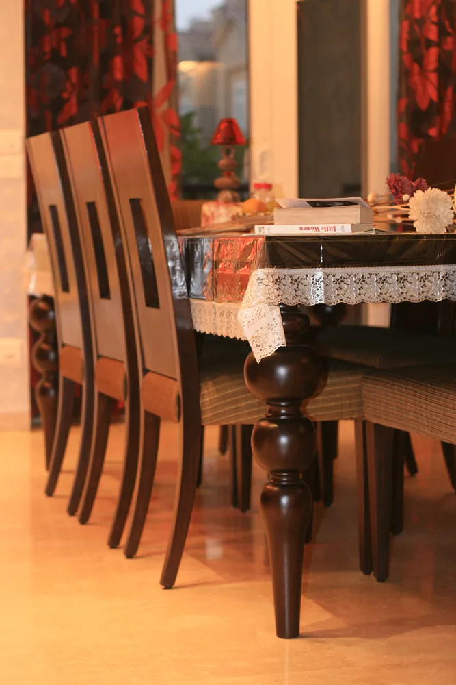 Solid timber dining table leg detail at Palm Springs Villa, Gurgaon by SpaceTalk Designs