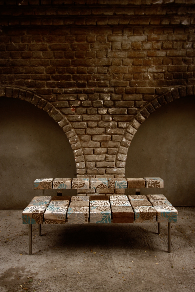 Checkerboard fabric puzzle settee against brick wall by SpaceTalk Designs, Gurgaon
