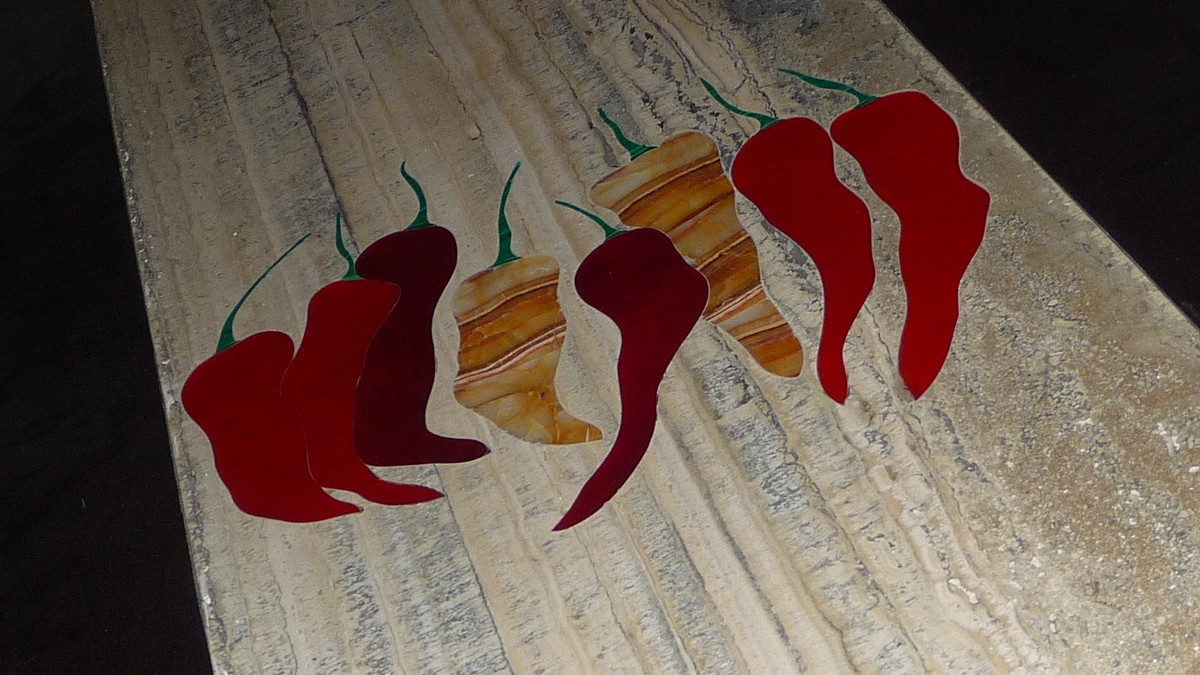 Travertine stone dining table with red chili inlay by SpaceTalk Designs, Gurgaon