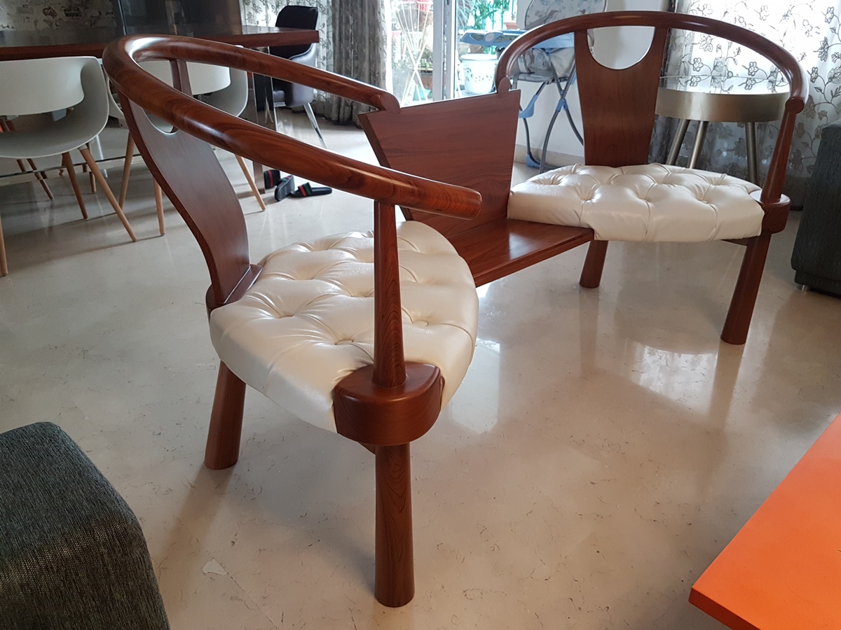 Custom double-seater tete-a-tete in solid wood and white leather by SpaceTalk Designs, Gurgaon